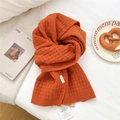 Detail showing the 100% wool material label and orange knit texture of the winter scarf - 29*167cm / Orange