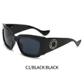 Lunettes de soleil noires surdimensionnées avec décoration ronde dorée sur la branche - Monture Noire Verres Noir Gris