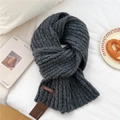 Close-up of chunky dark grey knit scarf with brand label and thick cozy texture - Dark Gray