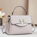 Detail of light purple pebbled leather bag with gold shield lock and top handle - Gray