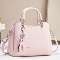 Pink lychee grain shoulder bag with star charm and silver hardware on white background - Pink