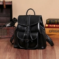 Dettaglio dello zaino in pelle cerata nera con tasca frontale su pavimento in legno - 30cmx28cmx12cm / Nero