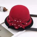 Close-up of red wool felt hat with black faux fur trim and pearl flower detail - M / Beaded Flower with Hemming / Burgundy