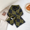 Detail of cross-insert argyle knit wool scarf in grey and olive green on a white bed - Green Gray