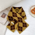 Detail of 100% wool knitted scarf showing retro argyle pattern and material label - Yellow Brown