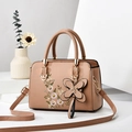 Elegant apricot leather handbag featuring floral embroidery and butterfly charm accent - Khaki
