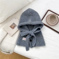 Close-up of blue ribbed knit balaclava scarf with drawstring, button detail, and white label - Melange Blue Coffee With Button