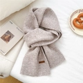 Detail of oatmeal knit scarf texture with a brown leather tag on soft fabric - 31*187cm / White Coffee
