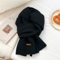 Detailed view of thick black knitted scarf texture with premium brown leather label - 31*187cm / Black