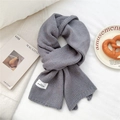 Detail of dark grey knit scarf with colorful specks and white brand label on white fabric - 23*160cm / Gray