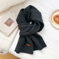 Detail of dark grey knitted scarf showing ribbed texture and brown leather label decoration - 31*187cm / Dark Grey