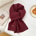 Macro shot of burgundy knitted scarf with leather logo patch and ribbed edge detail - 31*187cm / Burgundy