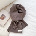 Close-up of brown knit scarf with bow decoration and brand label on white fabric - Dark Coffee Bow