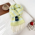 Close-up of thick striped wool scarf with long white fringes and soft knitted texture - Large Label Style / Yellow Green (Striped)
