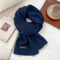 Close-up of dark blue ribbed knit scarf with a rectangular brand tag on cotton surface - 26*180cm / Navy Blue