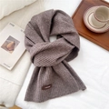 Close-up of ribbed knit texture on brown scarf with a leather brand patch detail - 26*180cm / Dark Coffee