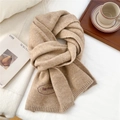 Close-up of beige knit scarf showing soft texture and red embroidered Egg doris logo - 28*186cm / Coffee