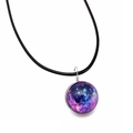 Macro shot of a handmade glass galaxy ball pendant with blue-purple starry nebula patterns - Purple