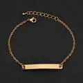 Macro detail of a minimalist rose gold stainless steel curved bar bracelet with adjustable chain - Gold