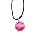 Macro detail of handmade cosmic galaxy glass orb pendant with colorful nebula and cord - Red