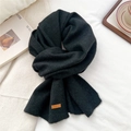 Detailed view of dark grey knitted scarf with premium leather brand label on white fabric - Navy Blue(05)