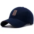Navy blue baseball cap with brown leather patch and contrast brim for casual outdoor wear - Blue