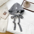 Grey knit hooded bonnet with long ties on a cozy white bedsheet for winter fashion - Medium Grey