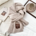 Detailed macro view of beige wool knit scarf texture with a handmade stitched label - One Size / Heathered Coffee