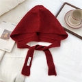 Flat lay of a red knit balaclava hat with drawstring and cozy winter decor on white cloth - Red