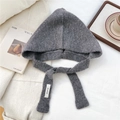 Close-up of gray knit hooded scarf showing thick texture and woven logo label - Gray
