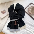 Detail of knitted scarf texture and brown leather label on white textured background - Black Border Style