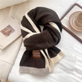 Detail of soft knit texture and contrast label on two-tone striped winter scarf - 48x180cm / Brown