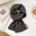 Deep dark green wool knit scarf featuring thick vertical ribs and premium brand labels - Smoke