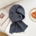 Deep gray chunky knit wool scarf with decorative button and tag on a soft background - Gray
