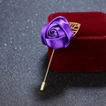 Elegant purple ribbon rose brooch with long golden pin and leaf detail on red velvet - Dark Purple
