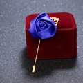 Blue fabric rose brooch with golden metal leaves and long pin on red velvet - Blue