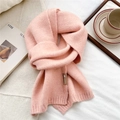 Detail of soft pink knit scarf texture with ribbed edge and elegant decorative brand tag - Pink