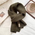 Detailed texture of dark moss green knitted scarf with premium leather brand label - Olive Green