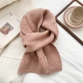 Macro detail of Morandi pink knitted scarf texture with a small decorative sewn label - Nude