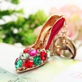 Golden high heel keychain with red and green rhinestones on floral background - Bright Red Crystal Shoe