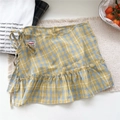 Detail of yellow and blue plaid layering skirt with ruffled hem and side tie closure - One Size / Yellow Check