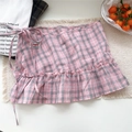 Detail of pink and grey plaid skirt with decorative ribbon tie and ruffled hemline - One Size / Pink Plaid
