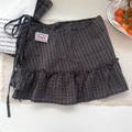 Detail of vintage dark plaid mini skirt with ruffle hem and BONOGEED brand label - One Size / Black Plaid