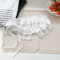 Close-up of white floral lace trim detailing with branded label on beige textile - Lace-up Wave Flower White / White