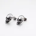 Mens skull stud earrings in retro silver stainless steel on white background - Skull Stud Earrings / Steel
