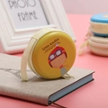 Round yellow tinplate coin purse featuring cartoon Little Amélie with secure zipper - Little Amélie Cartoon Girl Yellow Style 04