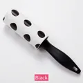 Mini portable lint roller with black polka dot paper and ergonomic black handle - Black
