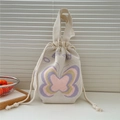 Detail of cream knit handbag featuring colorful butterfly patterns and drawstring closure - Multicolor Butterfly