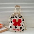 Detail of knitted drawstring handbag with polka dots and red flower embroidery - Polka Dot Bow