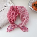 Pink cotton linen scarf with floral pattern tied in a knot on white background - 03 Woven Frame Forest Deep Pink